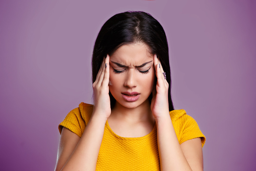 Woman experiencing migraine