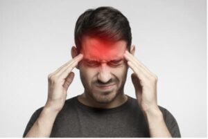 Man holding head with localized migraine pain.